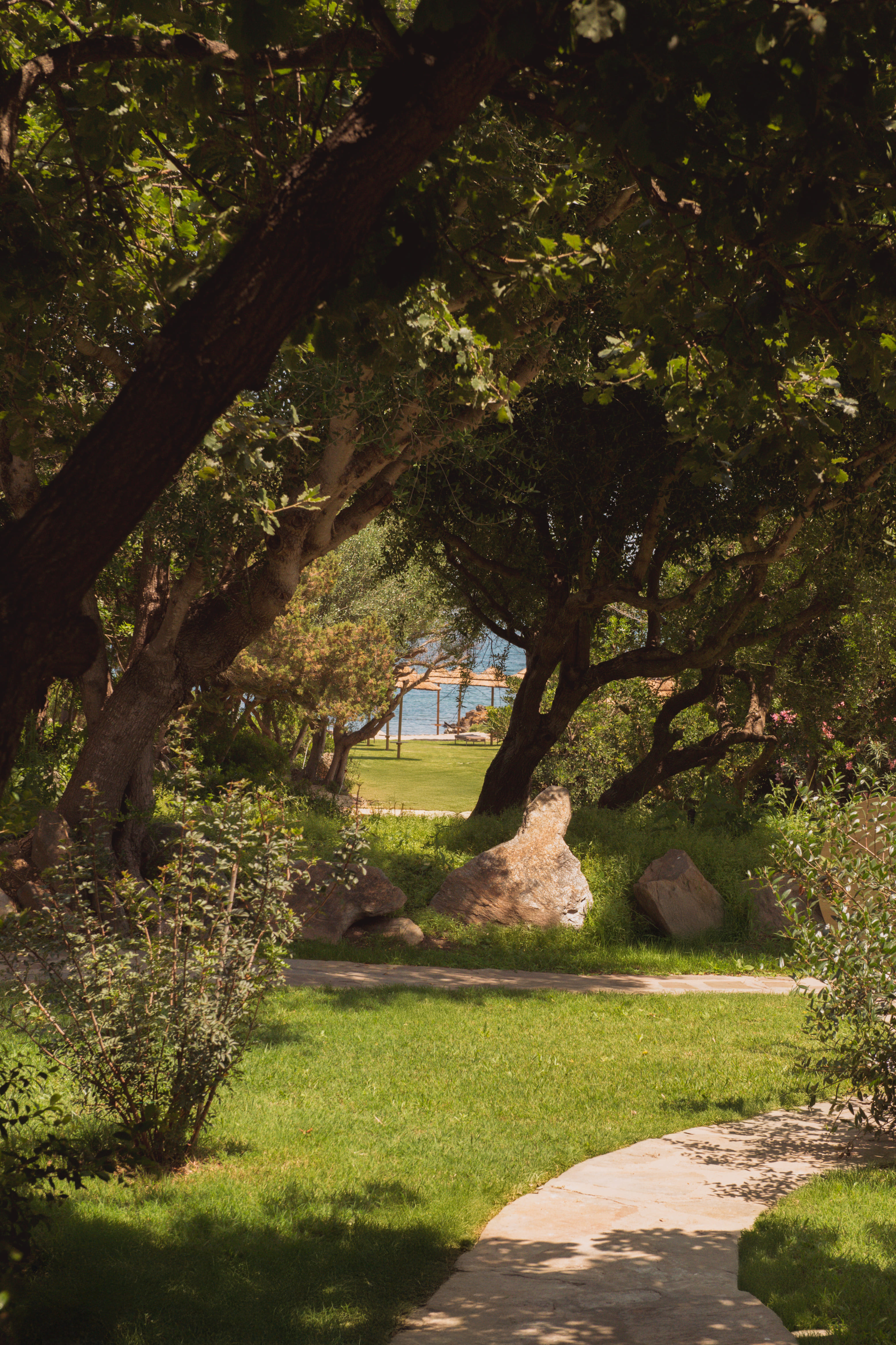 Private beach with umbrellas and loungers at Cala Lupo Resort