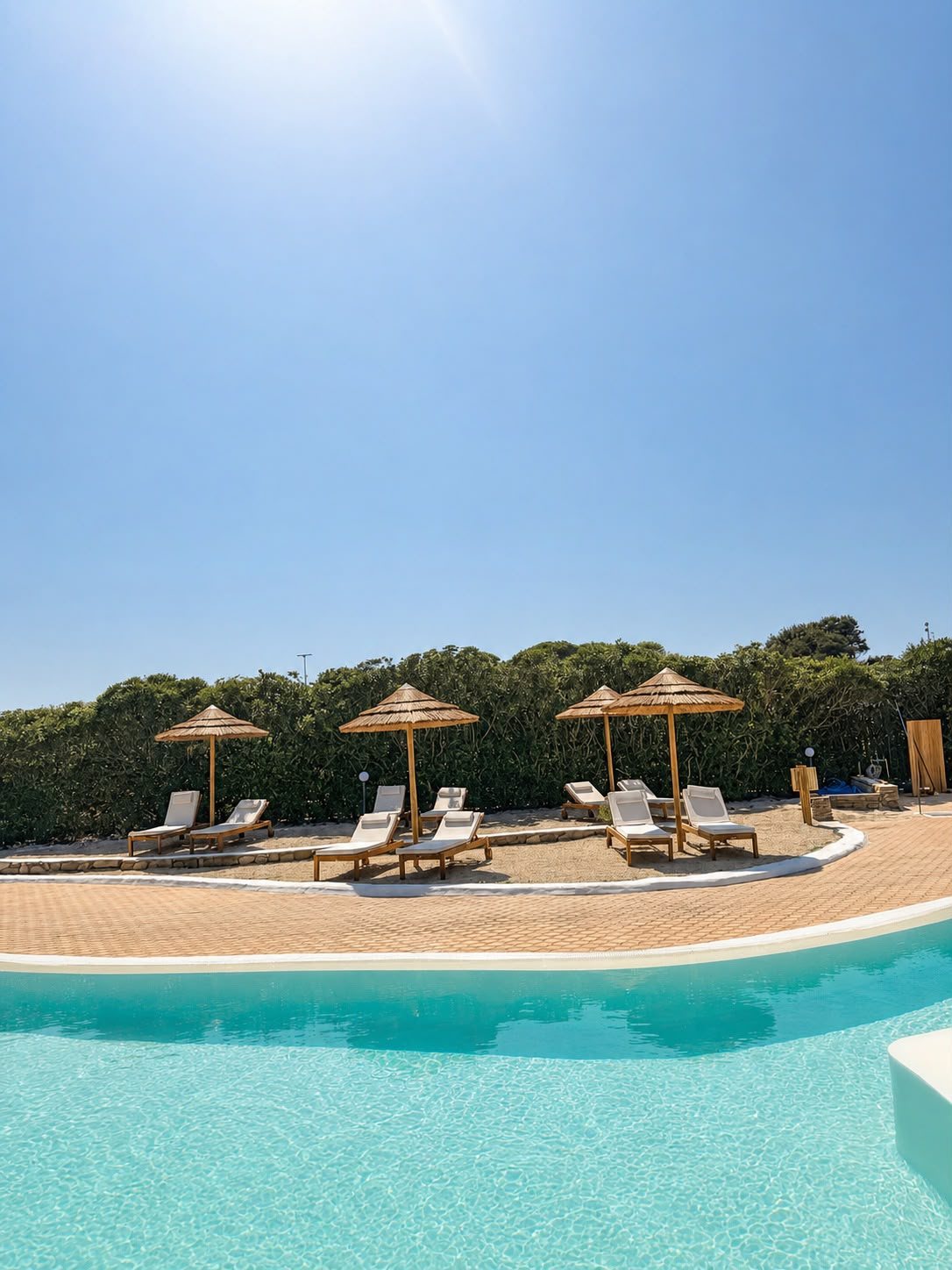 Sunbeds and umbrellas by the pool